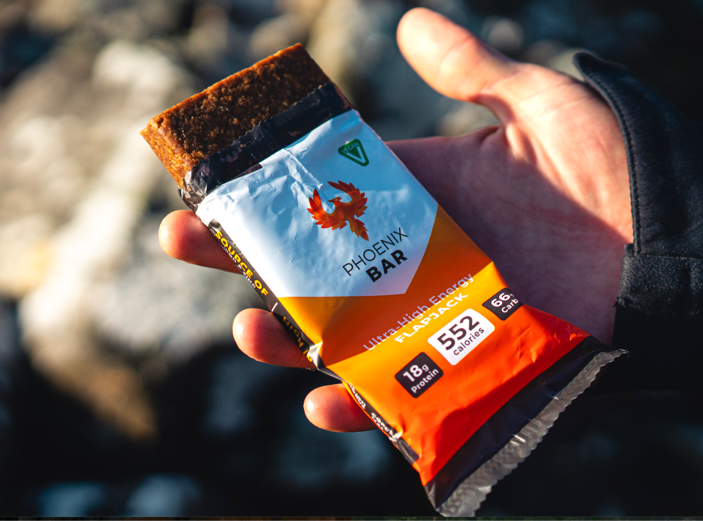 Half opened High Calorie Bar in the hands of someone on a mountaineering expedition