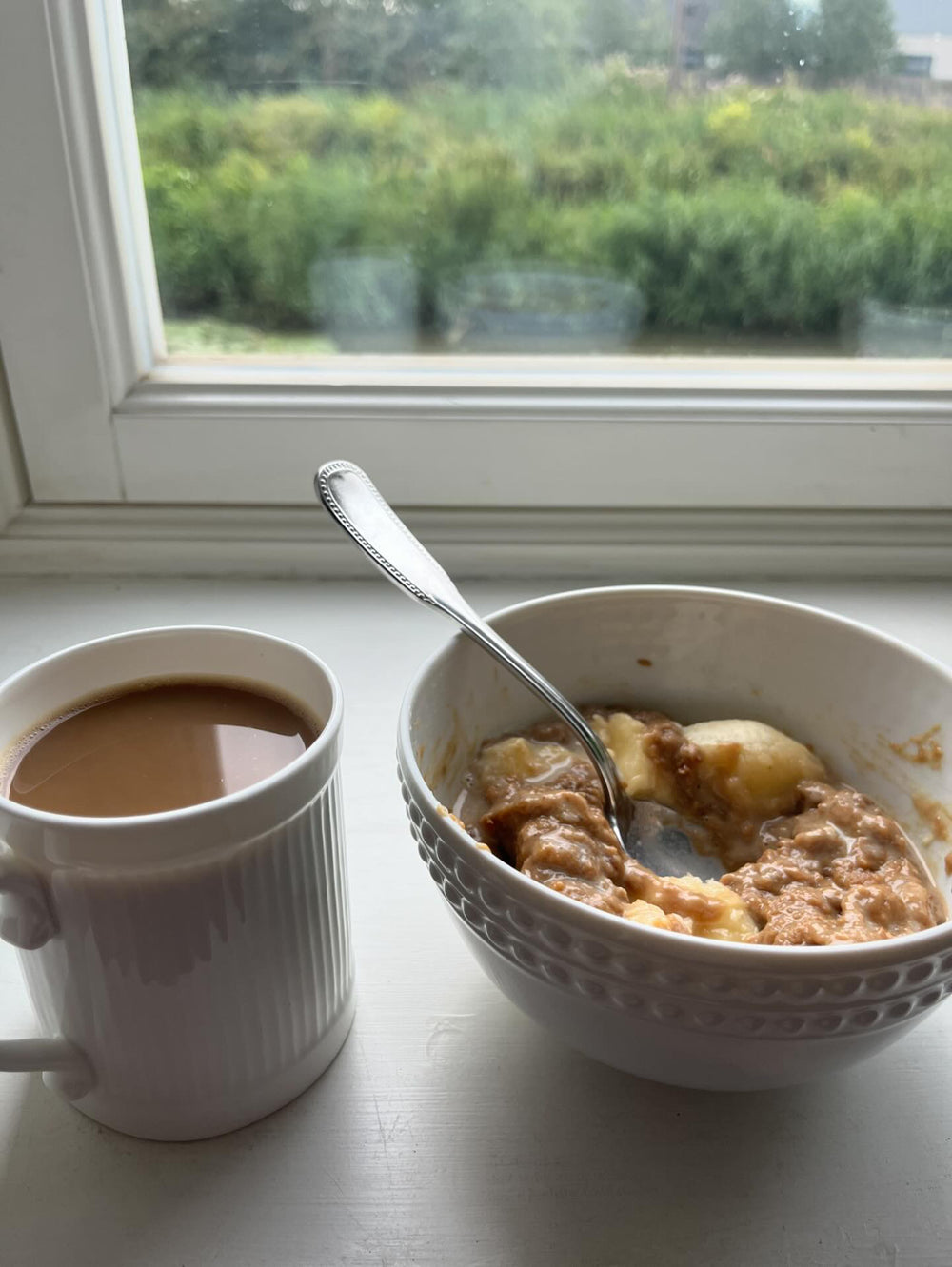 A bowl of Phoenix Bar porridge with a coffee