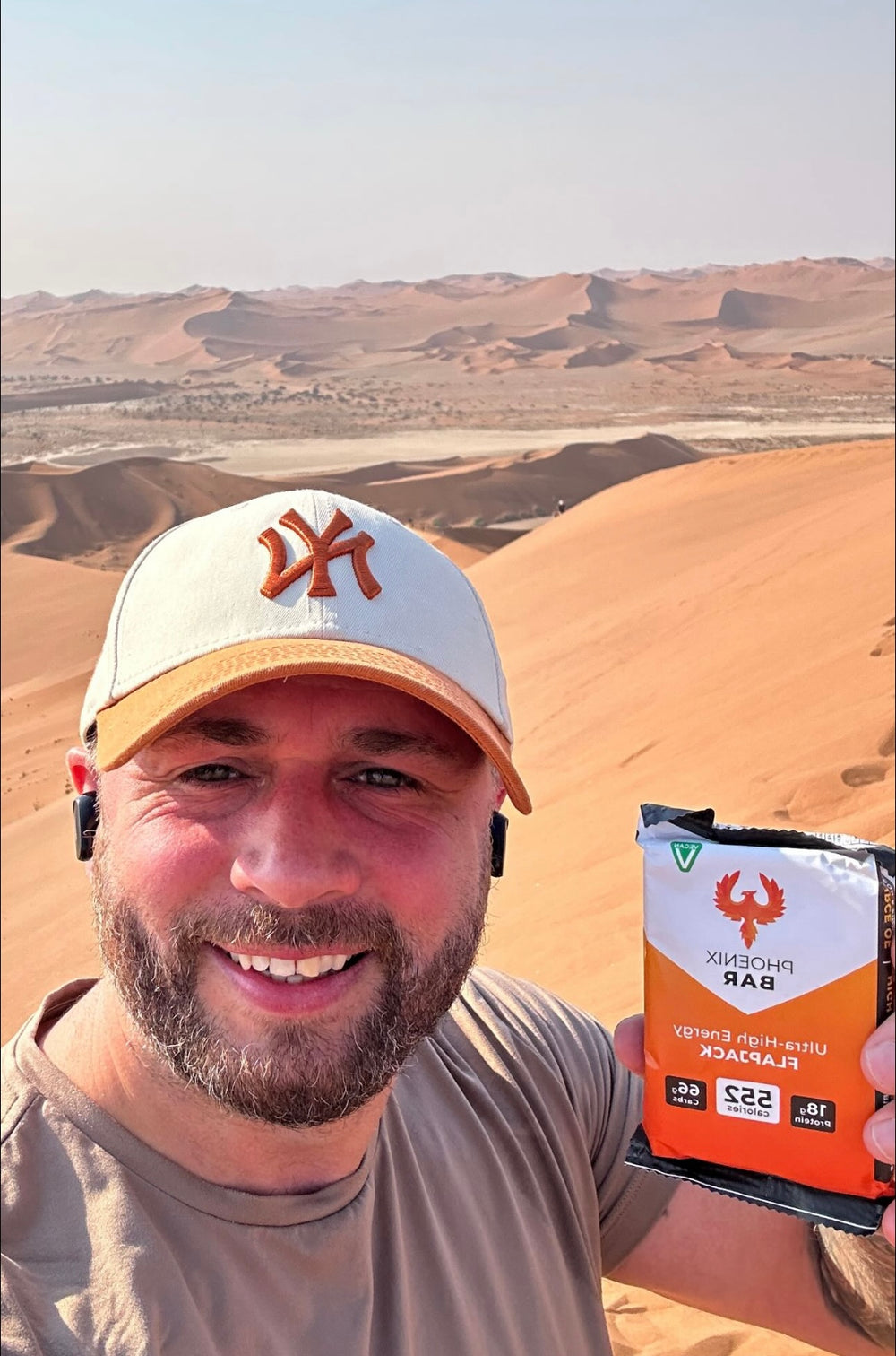 A runner in the desert holding a Phoenix Bar