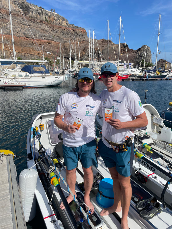 Two rowers holding Phoenix Bars on their boat