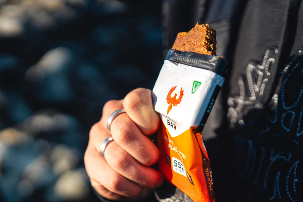 A half-eaten Phoenix Bar gripped in a fist outdoors