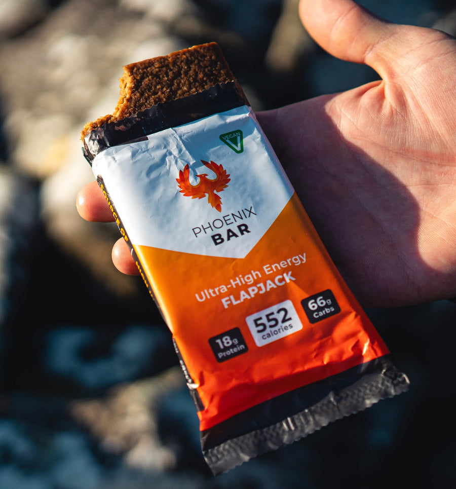 A Phoenix Bar with a bite taken out, held in one hand