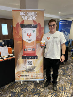 James at an event stand with a Phoenix Bar