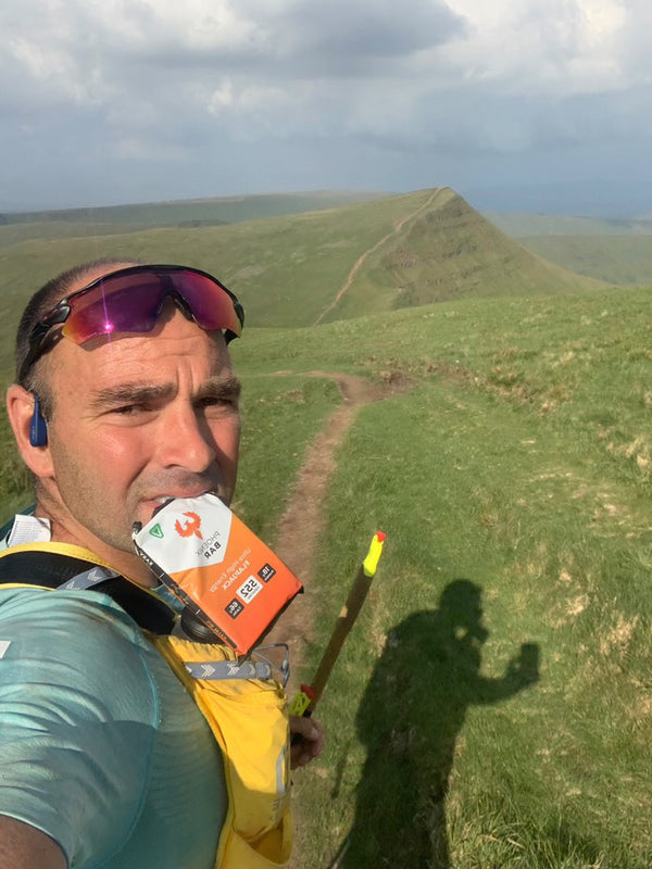 A trail runner with a Phoenix Bar on a ridge